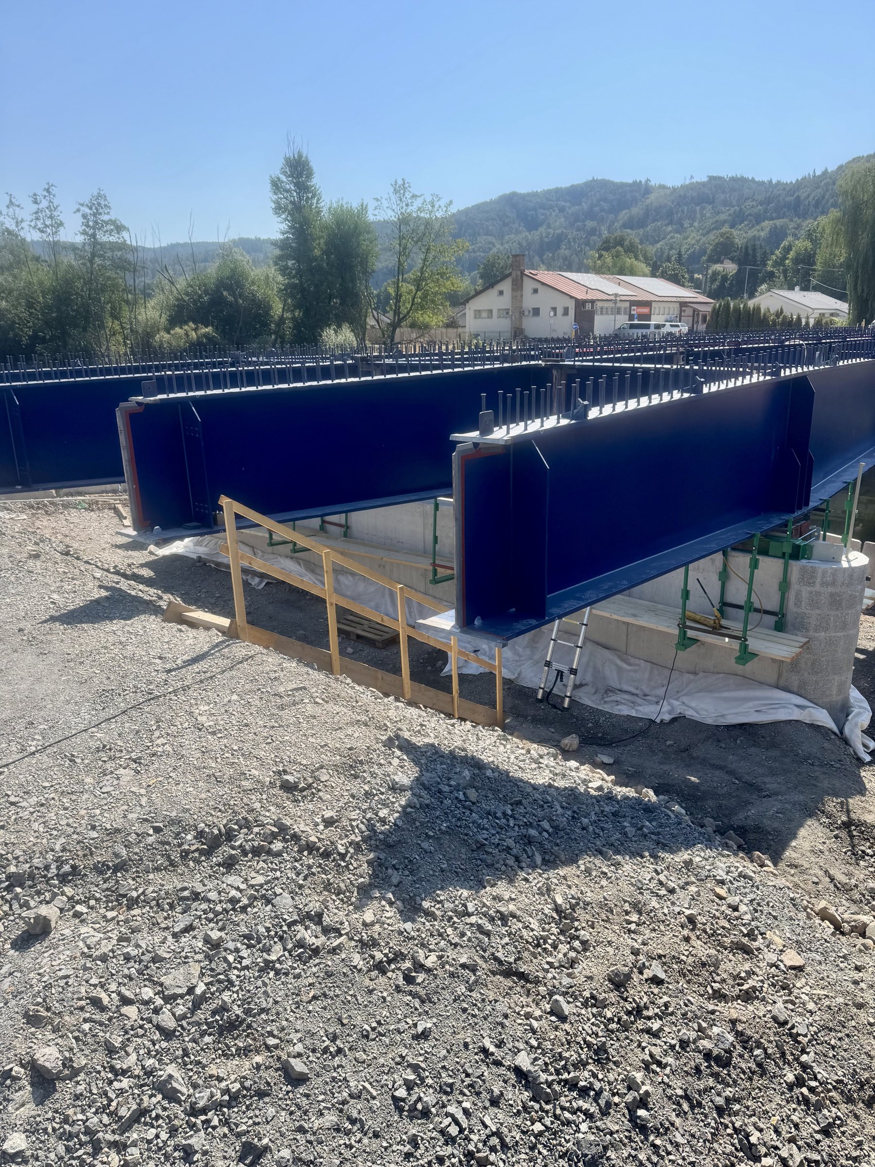 Two welded plate girders with rows of shear studs on the top flange and a bolted site splice